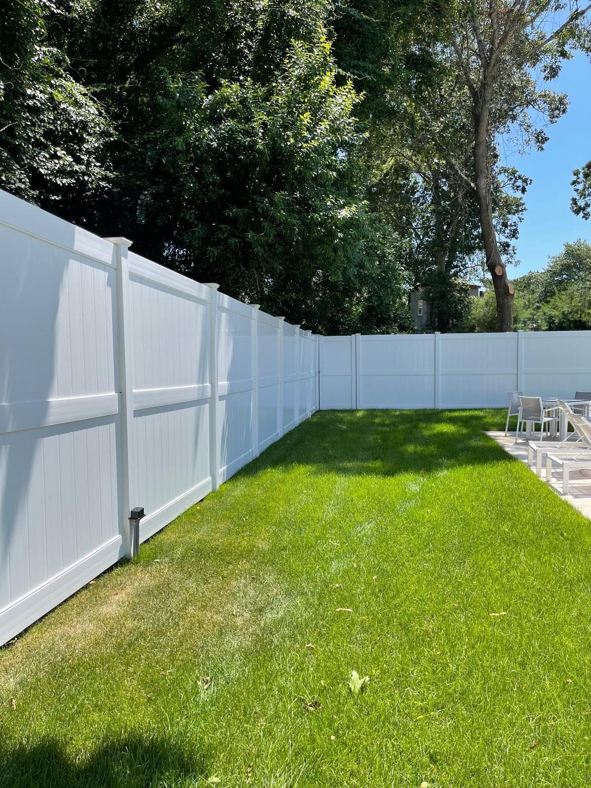 White vinyl privacy fence with gate section
