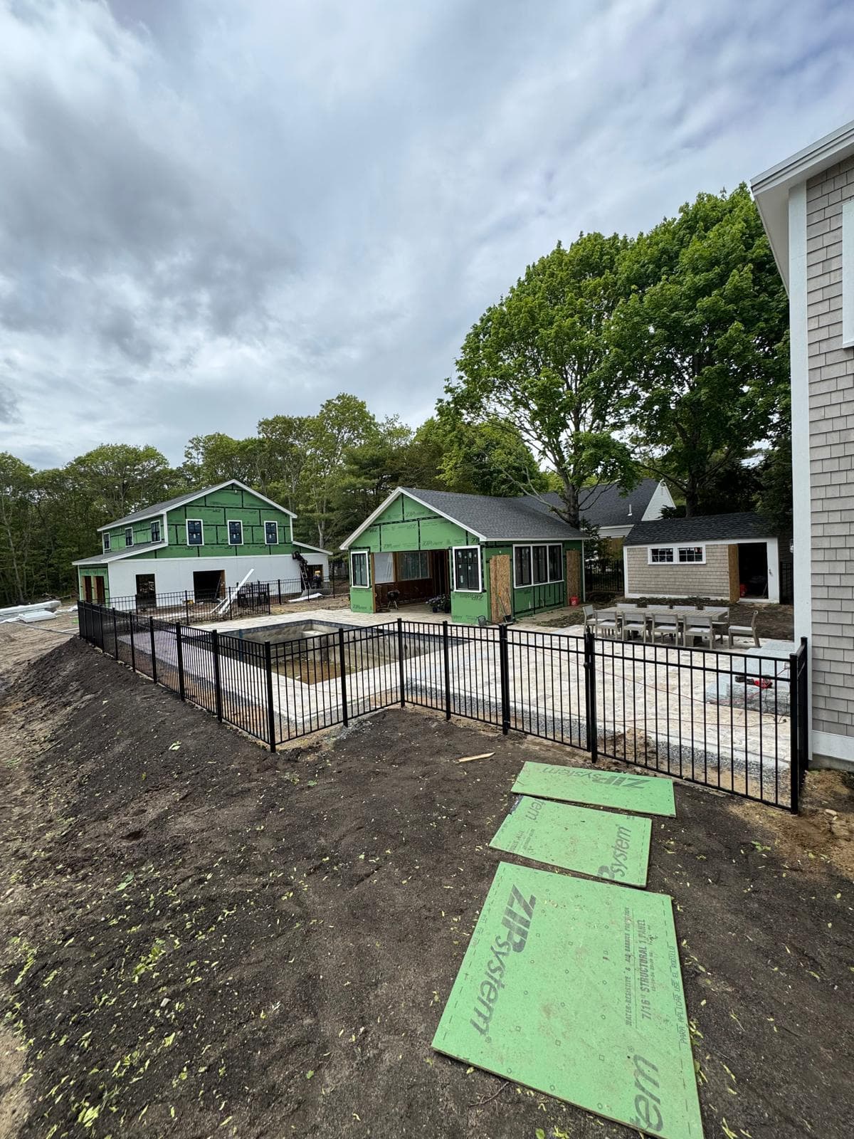 Black aluminum picket fence with sleek vertical rails on a modern Massachusetts residential property